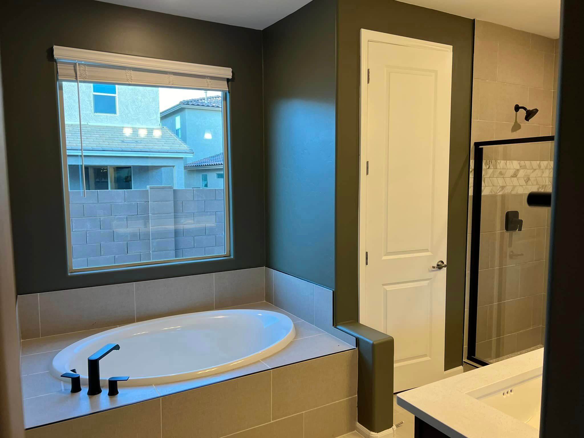 Expert painters applying premium paint to interior walls for a smooth, even finish. Bathroom Painting using Dunn- Edwards Paints