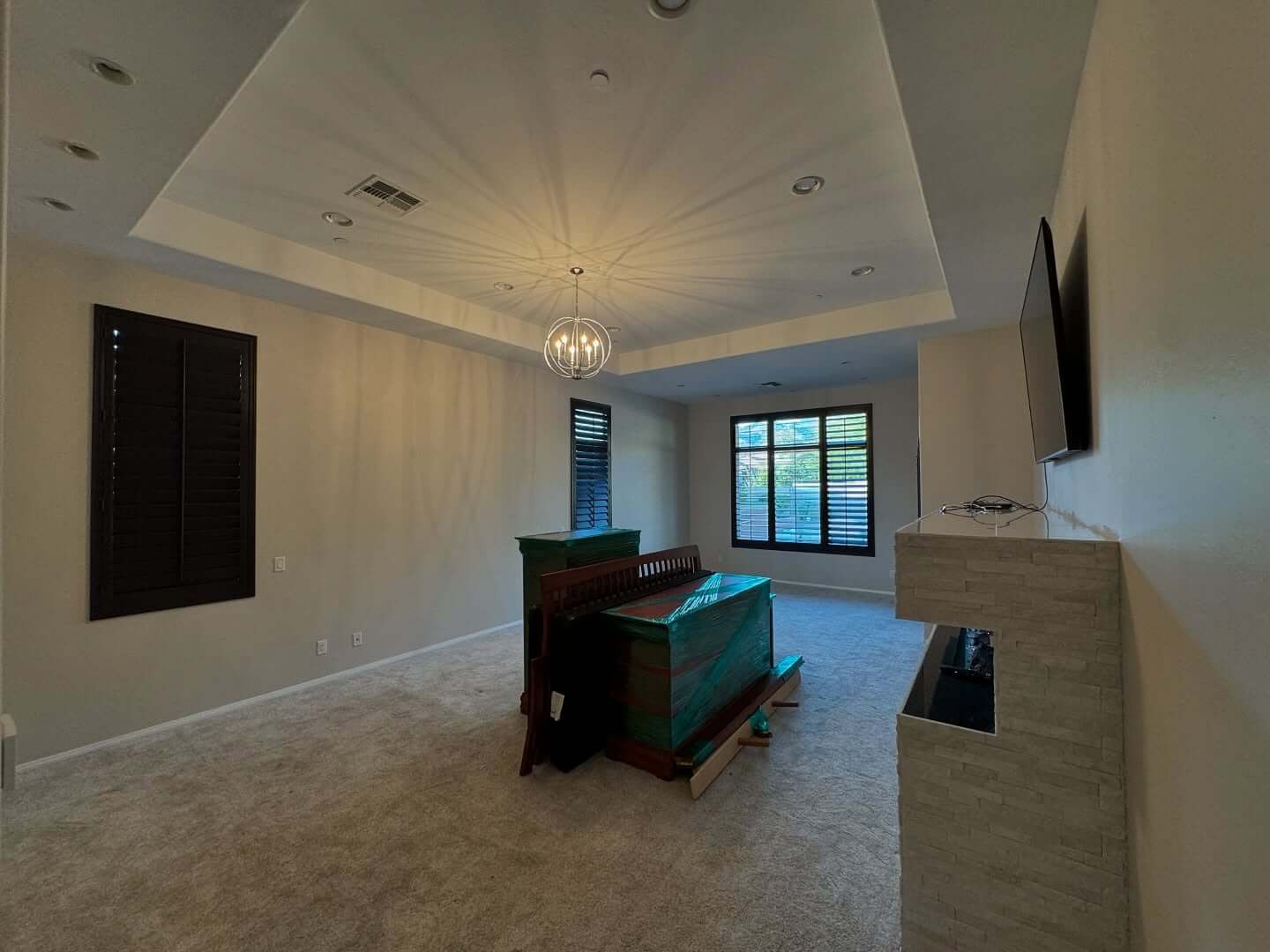 A freshly painted living room with modern, neutral tones enhancing the home’s aesthetic. Master bedroom painting